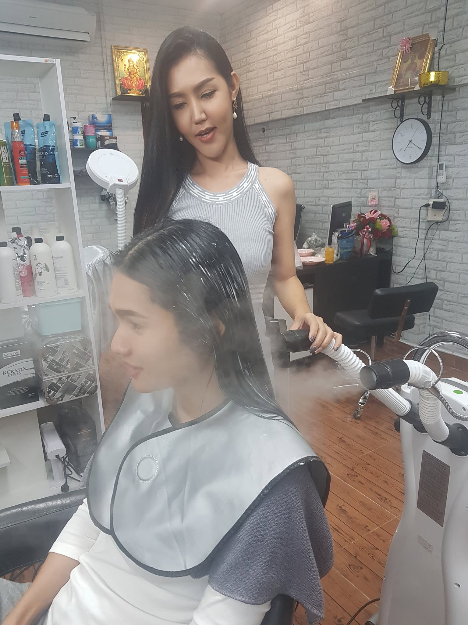 Chanya applying a salon hair treatment to a client